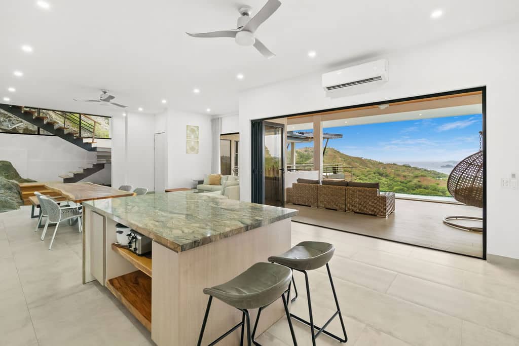 Floor-to-Ceiling Glass Sliders Connecting Kitchen & Ocean Terrace